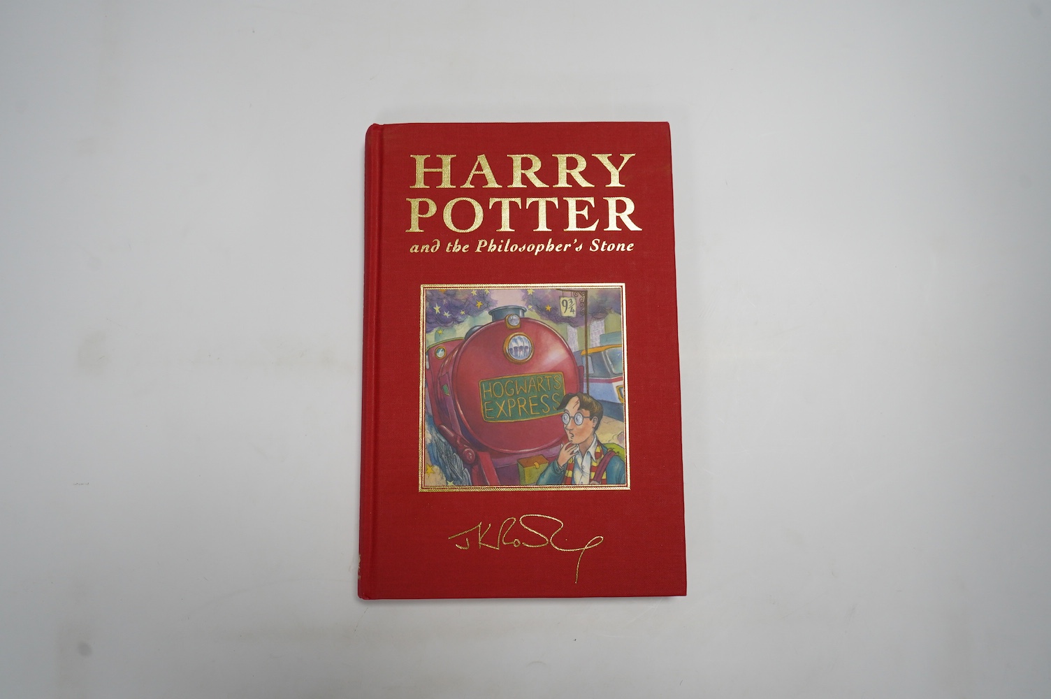 Rowling, J.K. - Harry Potter and the Philosopher's Stone. (De Luxe Edition). armorial half and title pages. publisher's gilt red cloth with mounted coloured illus. on upper cover, ge. and red e/ps. 1999; Rowling, J.K. -